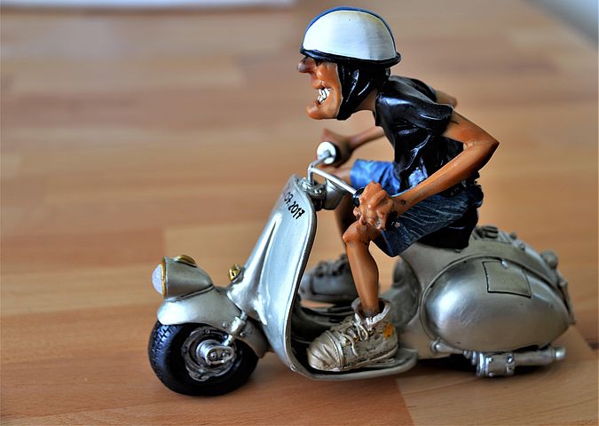 toy of man in scooter 