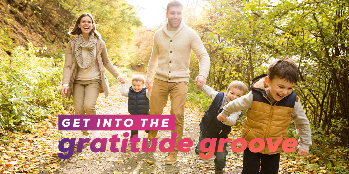 Family with 3 boys walking through nature. "Get Into the Gratitude Groove"