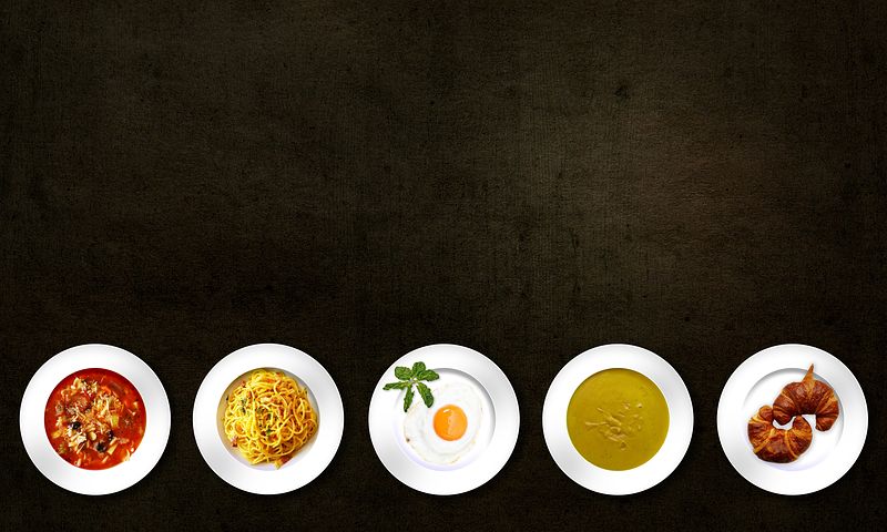 5 Plates of different types of food in black background