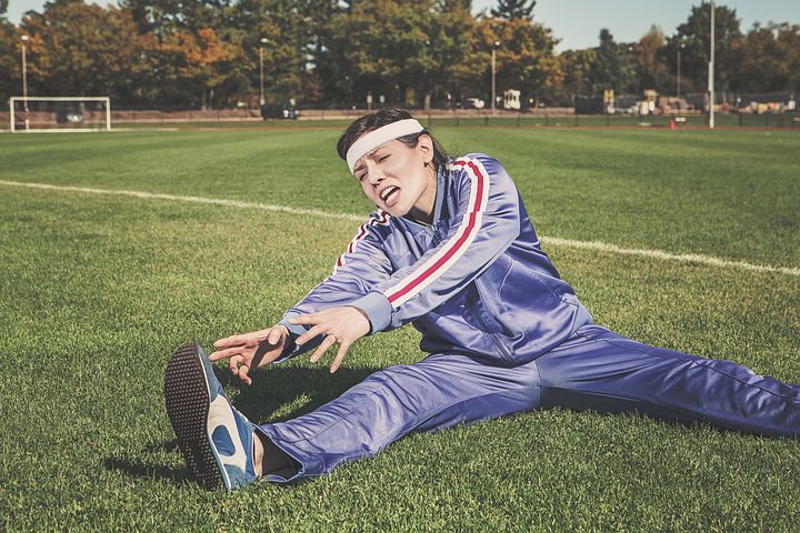 women stretching in a soccer ground