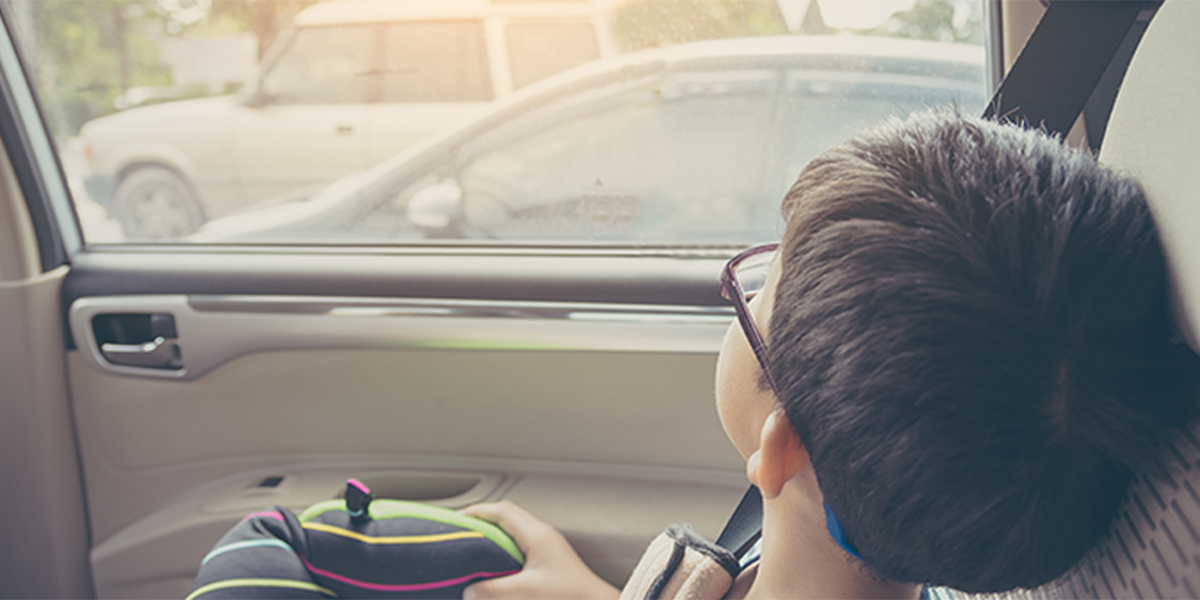 kid looking outside of a car