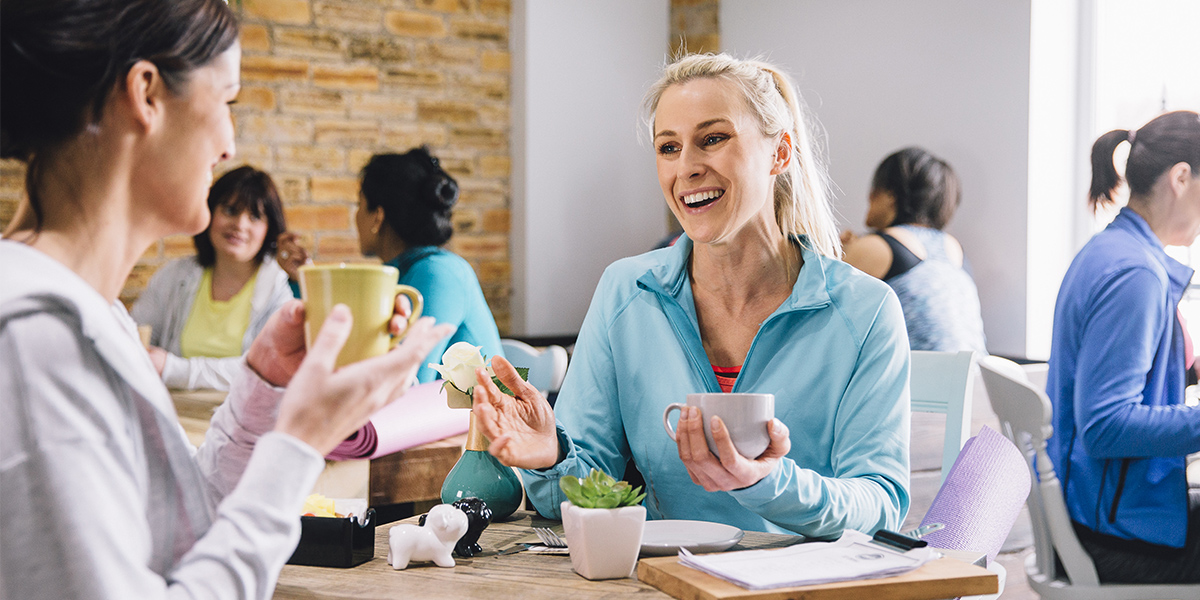 Women smiling and drinking coffee image