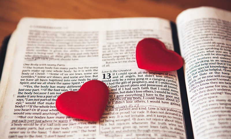 bible book with red hearts