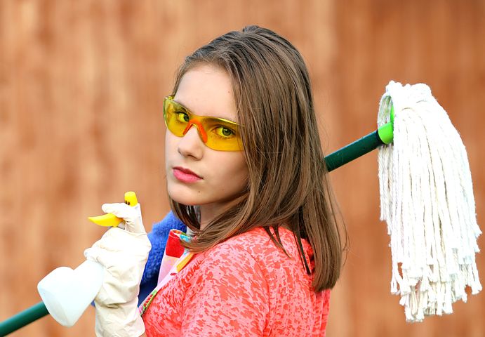 Girl holding mop and spray