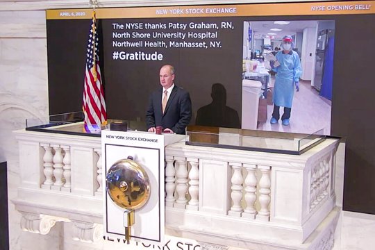 Chief Security Officer Kevin Fitzgibbons rings the opening bell at the NYSE, Monday, April 6, 2020, recognizing Patsy Graham, a registered nurse at North Shore University Hospital Northwell Health, in Manhasset, NY