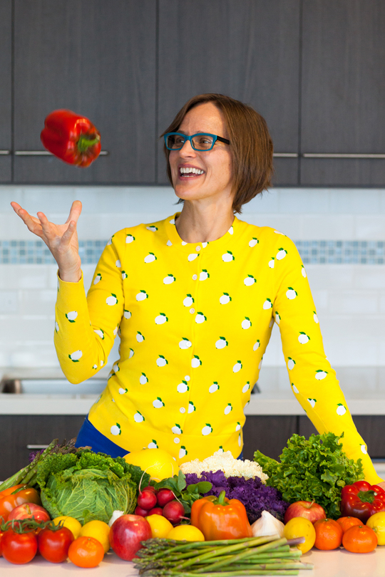 Food Literacy Center's founder Amber Stott tosses up a red bell pepper