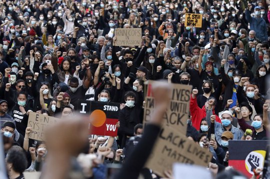 Protesters gather in Sydney, Saturday, June 6, 2020, to support the cause of U.S. protests over the death of George Floyd. Black Lives Matter protests across Australia proceeded mostly peacefully as thousands of demonstrators in state capitals honored the memory of Floyd and protested the deaths of indigenous Australians in custody.
