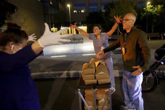 people giving food to nurses
