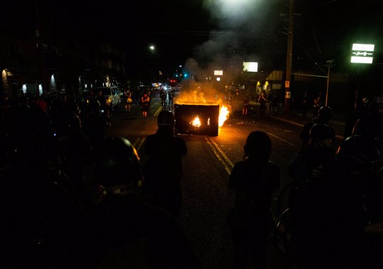 A waste receptacle is set on fire near the Portland Police Association building