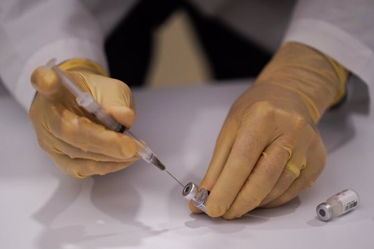 David Cheng, director of inpatient pharmacy, prepares the Pfizer-BioNTech COVID-19 vaccine at Kaiser Permanente Los Angeles Medical Center in Los Angeles