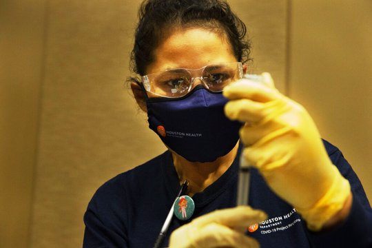 Nurse prepares dose of vaccine