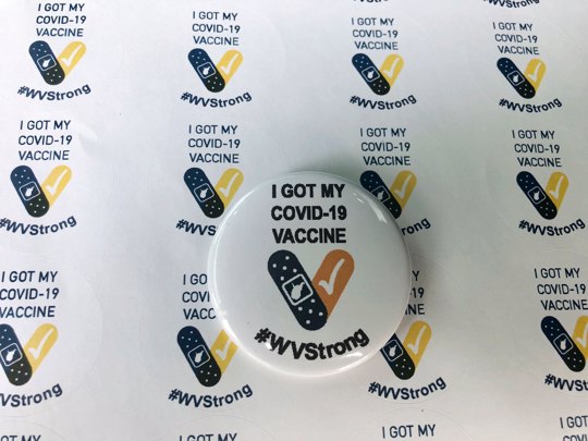 Stickers and a button given to people who receive their COVID-19 vaccines in West Virginia