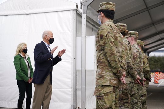 President Joe Biden and first lady Jill Biden meet with troops at a FEMA COVID-19 mass vaccination site at NRG Stadium in Houston