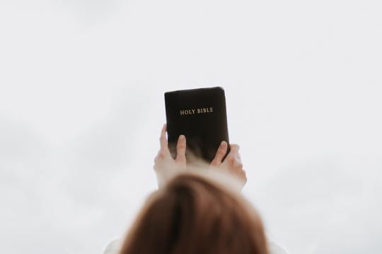 woman holding Bible