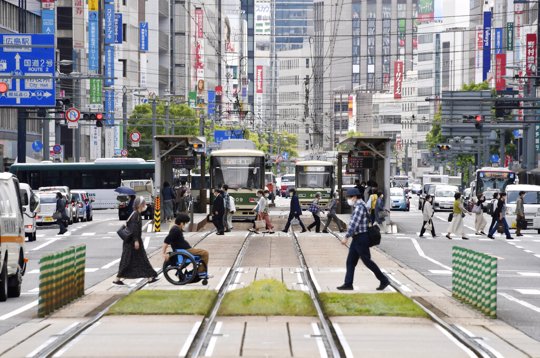 People wearing face masks make their way in Hiroshima