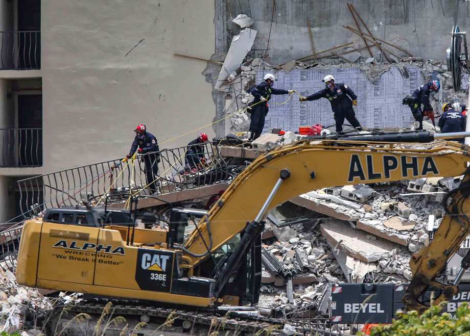 A South Florida Urban Search and Rescue team looks for survivors at the 12-story oceanfront condo, Champlain Towers South, Saturday, June 26, 2021, that partially collapsed early Thursday in the town of Surfside, Fla.