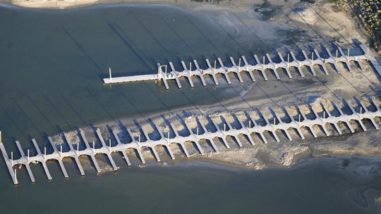Shallow water is seen from above at a boat dock at Antelope Island, Utah