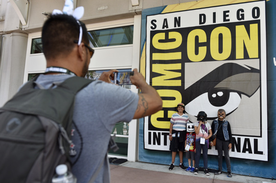 Luis Ramos, left, of San Diego takes a picture of his son, daughter, and their friends