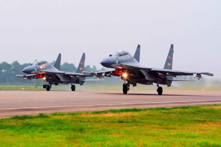 In this undated file photo released by China's Xinhua News Agency, two Chinese SU-30 fighter jets take off from an unspecified location to fly a patrol over the South China Sea.