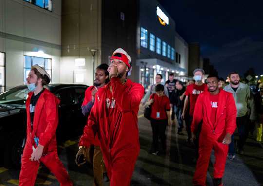 Chris Smalls, president of the Amazon Labor Union, center, joins supporters as they march and chant at the Amazon distribution center in the Staten Island borough of New York, Monday, Oct. 25, 2021, after earlier delivering "Authorization of Representation" forms to the National Labor Relations Board in New York.