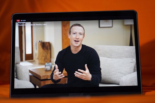 Seen on the screen of a device in Sausalito, Calif., Facebook CEO Mark Zuckerberg delivers the keynote address during a virtual event