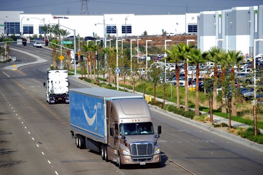 A semi-truck turns into an Amazon Fulfillment center
