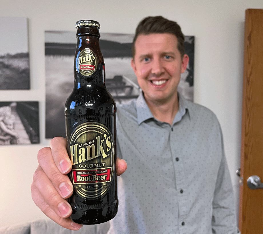 Matt Dearden holds a bottle of his recommended root beer, Hank’s