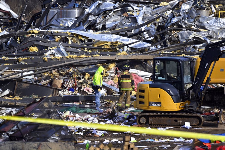 Emergency response workers dig through the rubble of the Mayfield Consumer Products candle factory in Mayfield, Ky.