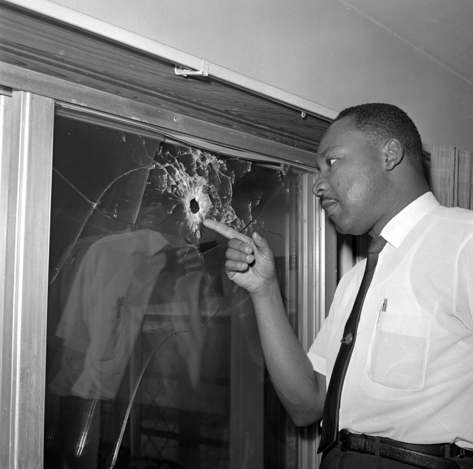 1964, file photo, Dr. Martin Luther King Jr. looks at a glass door of his rented beach cottage in St. Augustine, Fla., that was shot into. The house connected to King is now in the hands of a couple who plans to preserve it. 