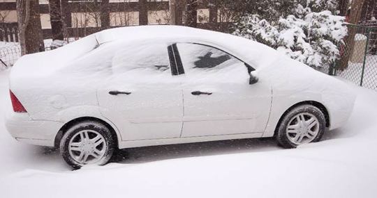 White car covered in snow