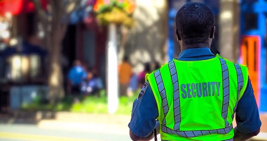 Man in a neon yellow security vest