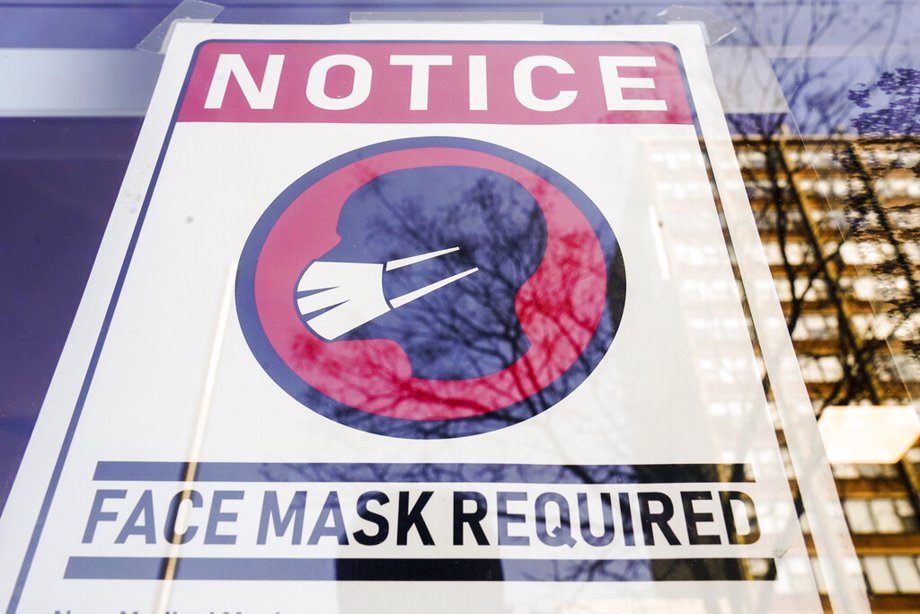 A sign requiring masks as a precaution against the spread of the coronavirus on a store front in Philadelphia