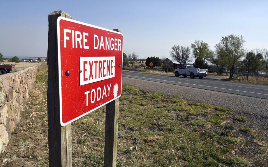 A fire warning sign is pictured in Las Vegas, N.M., on Tuesday, May 3, 2022. Flames raced across more of New Mexico's pine-covered mountainsides, Tuesday, May 3, 2030, charring more than 217 square miles over the last several weeks.