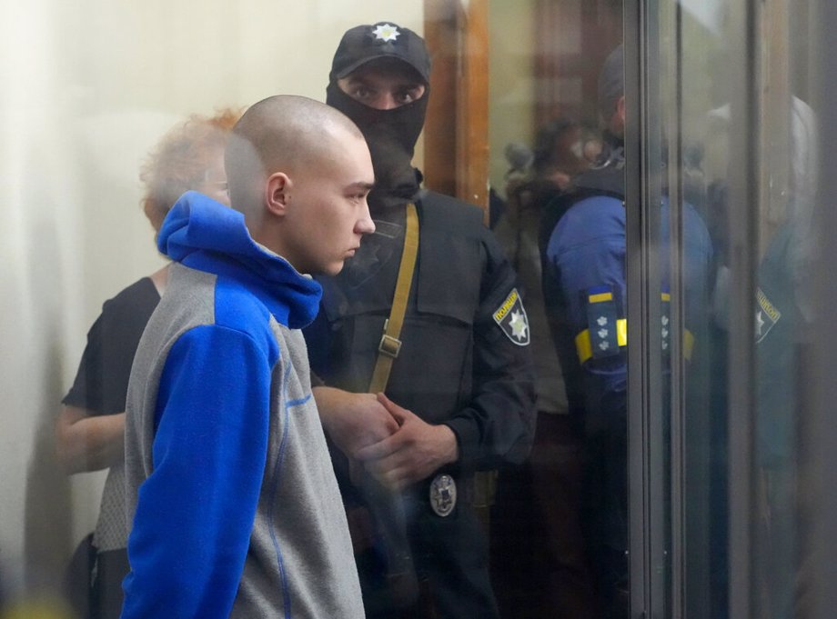 Russian army Sergeant Vadim Shishimarin, 21, is seen behind a glass during a court hearing in Kyiv, Ukraine. He's accused in the death of a civilian.