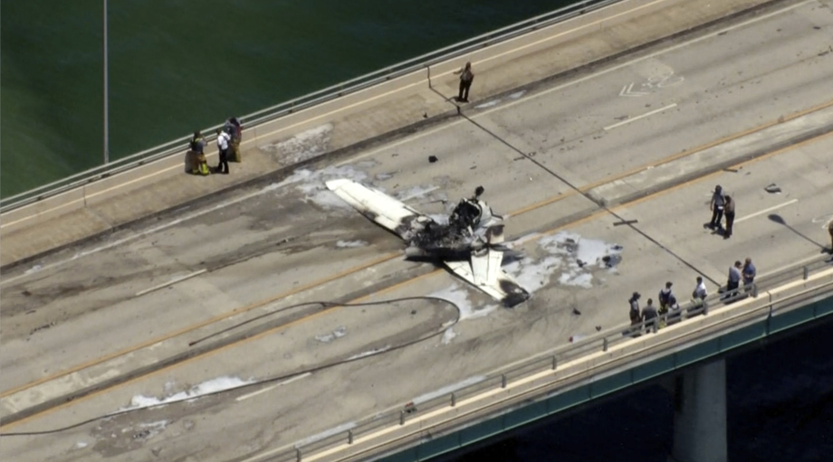 This photo provided by WSVN-TV emergency personnel respond to a small plane crash in Miami on Saturday, May 14, 2022.