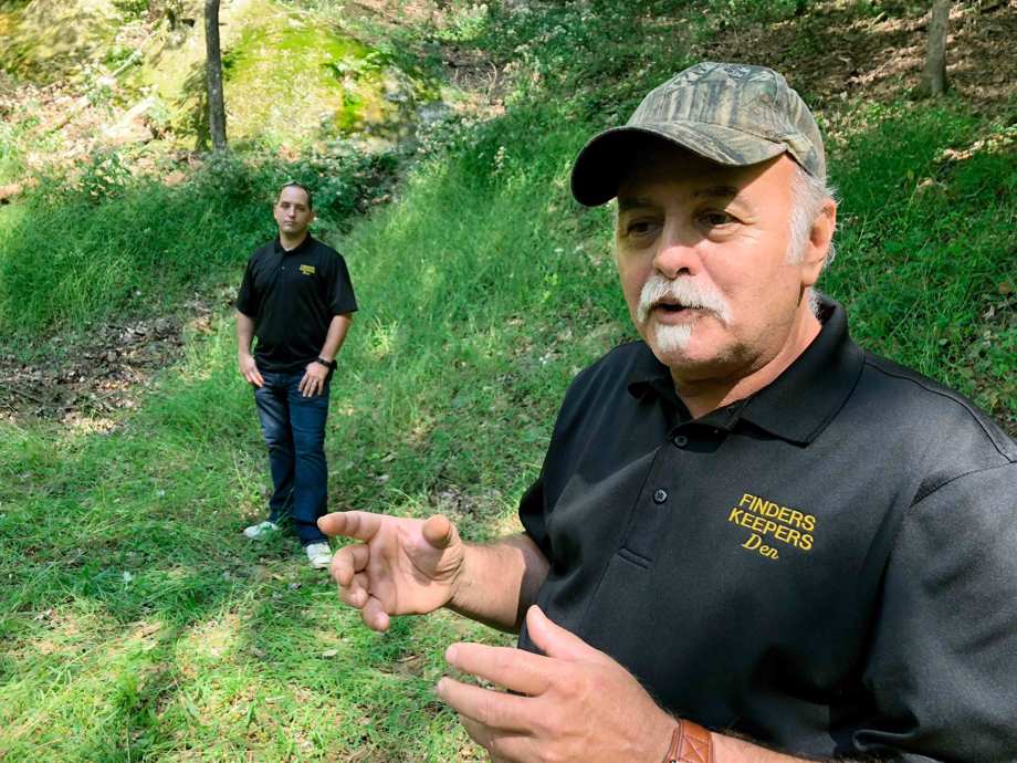 Dennis Parada, right, and his son Kem Parada stand at the site of the FBI's dig for Civil War-era gold in Sept, 2018, in Dents Run, Pennsylvania.