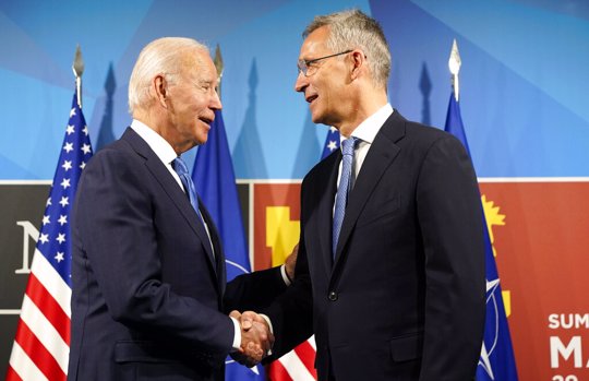 President Joe Biden, left, is greeted by NATO Secretary General Jens Stoltenberg during arrival for a NATO summit in Madrid, Spain