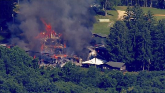 This image taken from video provided by WJLA shows crews battling a fire at Camp Airy for Boys in Thurmont, Md., on Wednesday, June 29, 2022. The building was empty when the fire broke out and no injuries have been reported, Frederick County Division of Fire & Rescue Services spokesperson Sarah Campbell said. Residents and campers were not in the area of the fire, she said.