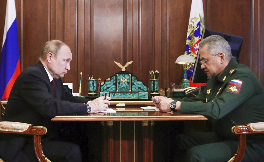 Russian President Vladimir Putin, left, listens to Russian Defense Minister Sergei Shoigu