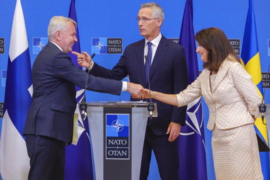 Finland's Foreign Minister Pekka Haavisto, left, Sweden's Foreign Minister Ann Linde, right, and NATO Secretary General Jens Stoltenberg