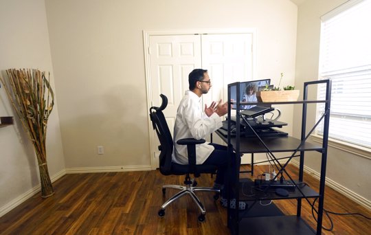 Medical director of Doctor on Demand Dr. Vibin Roy speaks to a patient during an online primary care visit conducted from his home