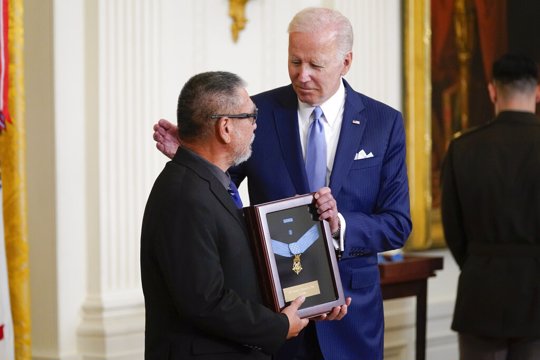 President Joe Biden presents the Medal of Honor to Staff Sgt. Edward Kaneshiro for his actions on Dec. 1, 1966, during the Vietnam War, as his son John Kaneshiro accepts the posthumous recognitionduring a ceremony in the East Room of the White House