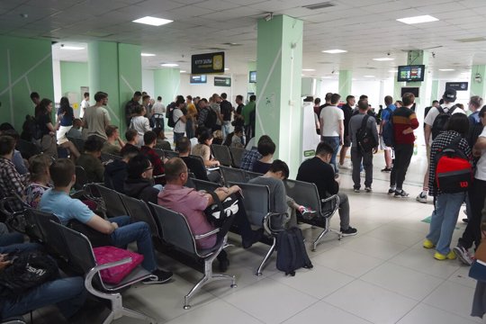 Russians wait and lineup to get Kazakhstan's INN in a public service center in Almaty, Kazakhstan