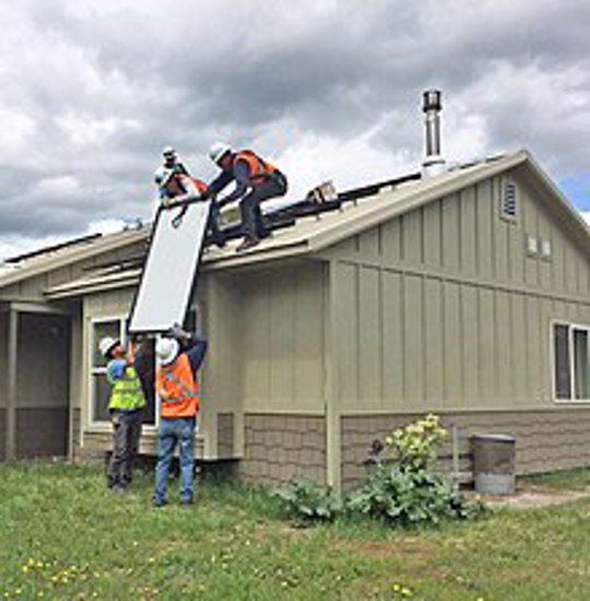 Workers installing solar panels