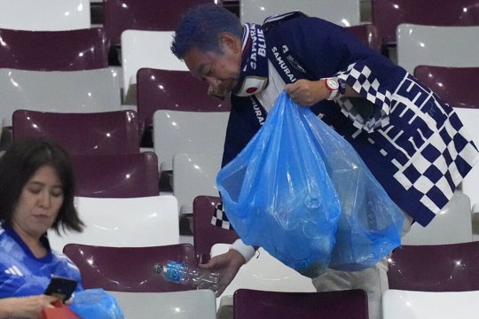 Japan supporters clean the stands