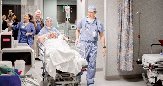 Patient on gurney getting wheeled into surgery