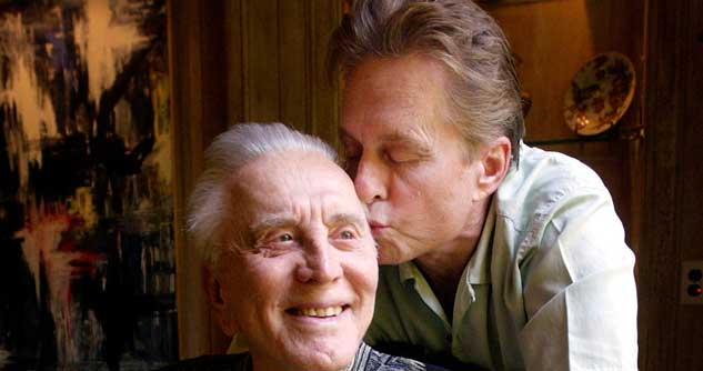 Actor Michael Douglas kisses his father, legendary actor Kirk Douglas