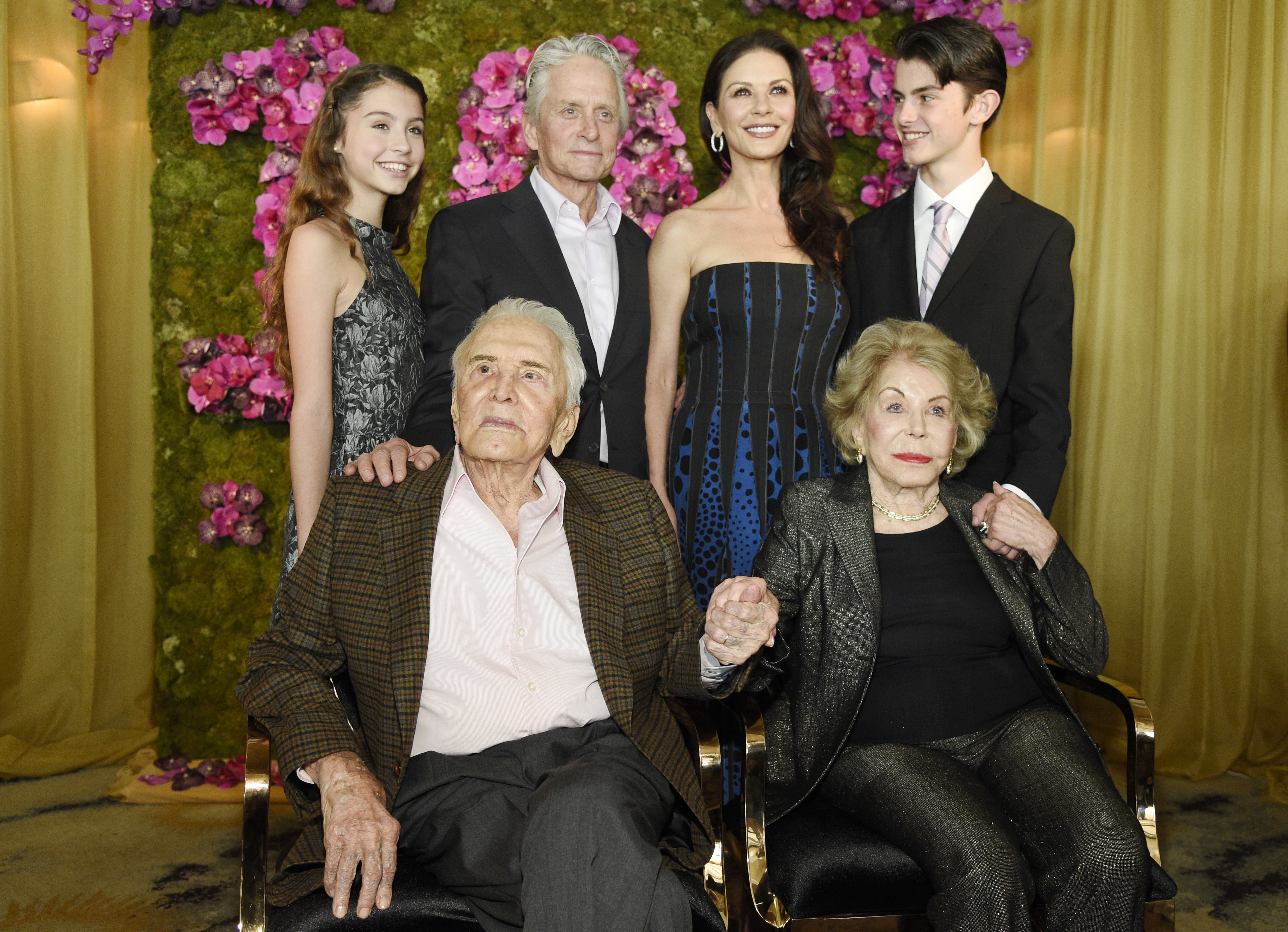 actor Kirk Douglas with his wife Anne Douglas pose with family members