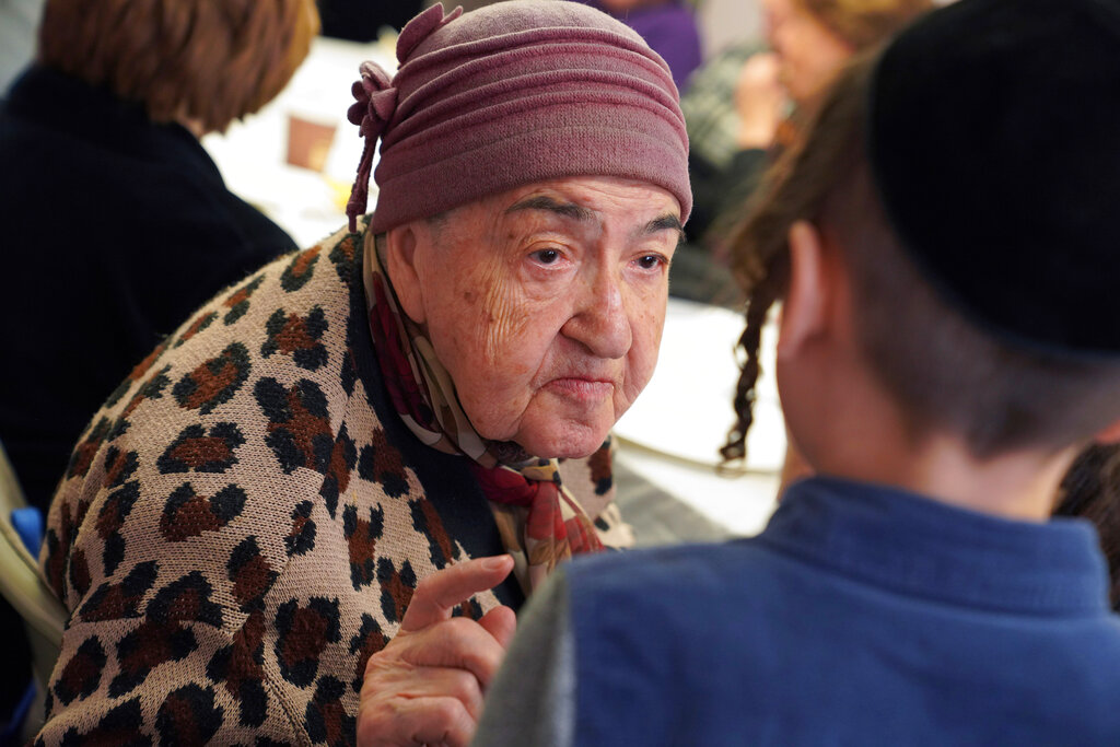 Holocaust survivor Tatanya Belkovskaya, talks to Avrumy Cisner, 9, after Cisner sang at the Nachas Family and Health Network in the Brooklyn borough of New York
