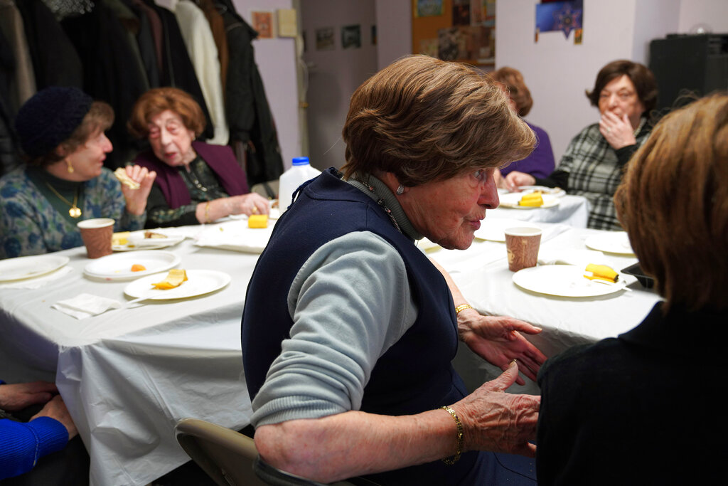Berta Einhorn, 89, center, and other Holocaust survivors share a meal and conversation at Nachas Health and Family Network in Brooklyn borough of New York